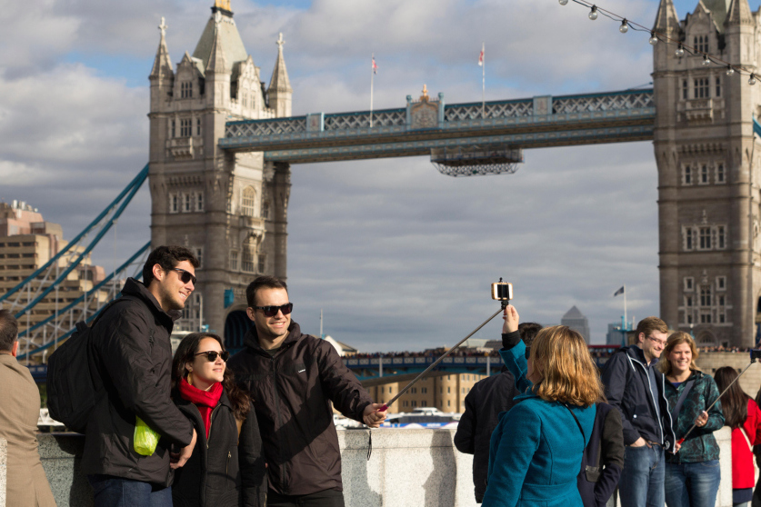 Tourists taking selfies with the help of a selfie stick by the Tower of London, South Bank, UK. Image shot 2014. Exact date unknown.